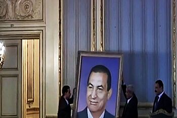 Removing a portrait of ex-president Ben Ali